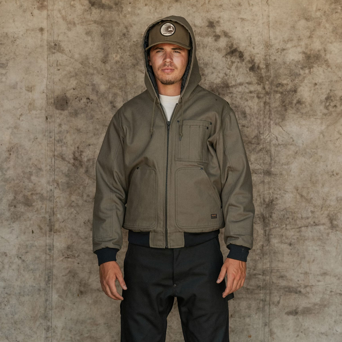 Filson Worksmith Insulated Bomber Jac Tarmac, with drawcord-adjustable hood providing a snug fit and extra protection from the elements