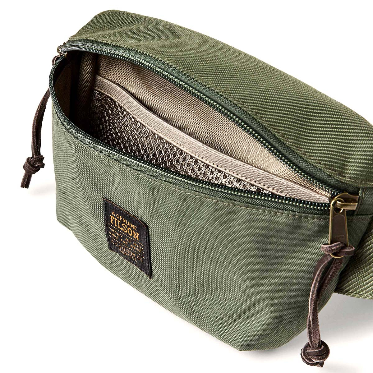 Filson Surveyor Crossbody Pack Service Green, lined interior with lightweight ripstop nylon and features a mesh devider